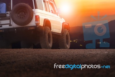 Sport Offroad Vehicle On Dirt Field Against Sun Set Sky For Traveling And Outdoor Lifestyle Stock Photo