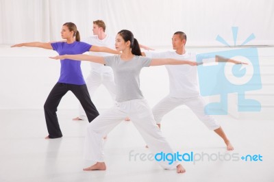 Sporty People Stretching Hands Yoga Class In Fitness Studio Stock Photo