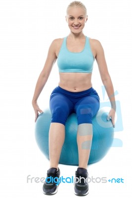 Sporty Woman Exercising With Blue Ball Stock Photo