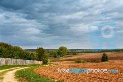 Spring Storm Clouds Above Country Road Stock Photo