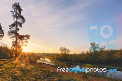 Spring Sun Rising Above Lake Stock Photo