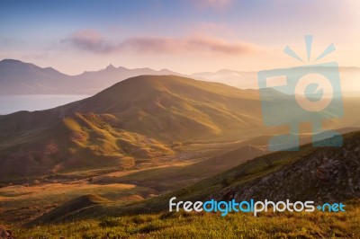 Spring Sunset In The Mountains. Seacoast And Hills Stock Photo