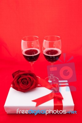 St Valentine's Setting With Present And Red Wine Stock Photo