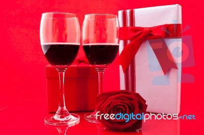 St Valentine's Setting With Present And Red Wine Stock Photo