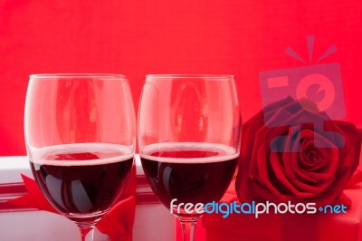 St Valentine's Setting With Present And Red Wine Stock Photo