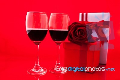 St Valentine's Setting With Present And Red Wine Stock Photo