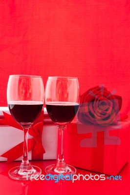 St Valentine's Setting With Present And Red Wine Stock Photo