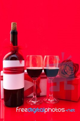 St Valentine's Setting With Present And Red Wine Stock Photo