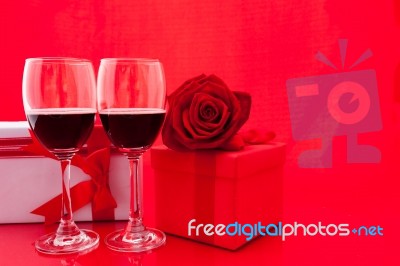 St Valentine's Setting With Present And Red Wine Stock Photo
