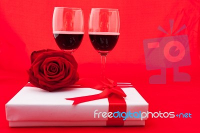 St Valentine's Setting With Present And Red Wine Stock Photo