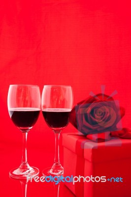 St Valentine's Setting With Present And Red Wine Stock Photo