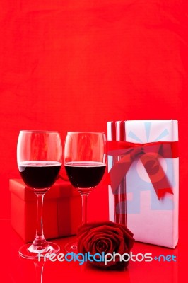 St Valentine's Setting With Present And Red Wine Stock Photo