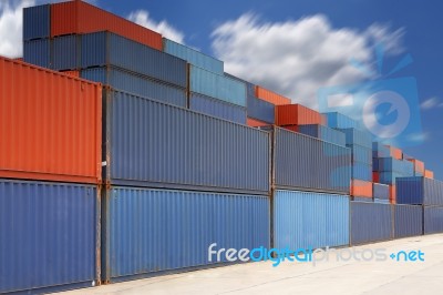 Stack Of Cargo Containers At Container Yard With Cloud Stock Photo