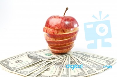 Stack Of Dollars Lays On Apple Stock Photo