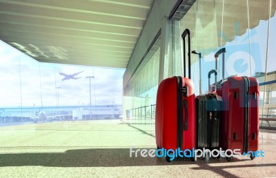 Stack Of Traveling Luggage In Airport Terminal And Passenger Plane Flying For Air Transport And Treveling Theme Stock Photo