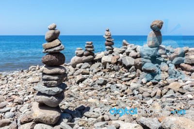 Stacked Beach Stones At Blue Sea Stock Photo