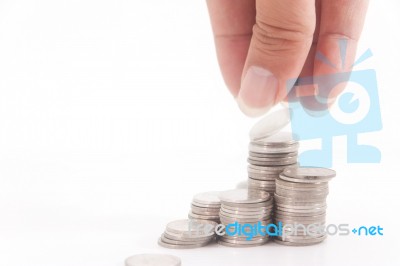 Stacking Coins By Hand Stock Photo