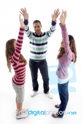 Standing Friends With Raised Arms Stock Photo