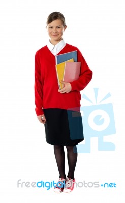 Standing Schoolgirl Holding Books Stock Photo