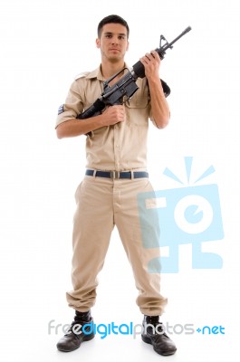 Standing Soldier Posing With Gun Stock Photo