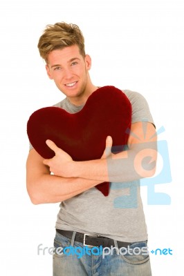 Standing Young Man Embracing Pillow Stock Photo