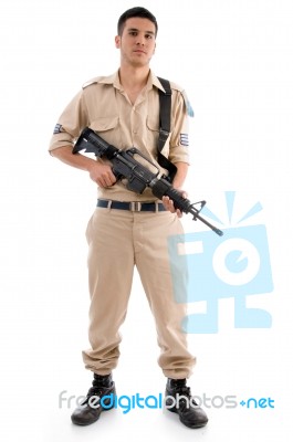 Standing Young Soldier With Gun Stock Photo