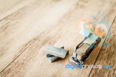 Stapler Paper On Wood Background Stock Photo