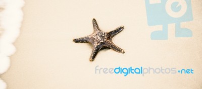 Starfish On The Beach Sand. Close Up Stock Photo