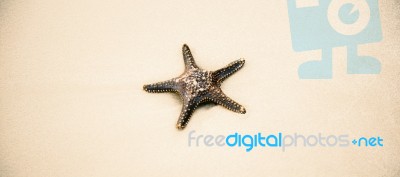 Starfish On The Beach Sand. Close Up Stock Photo