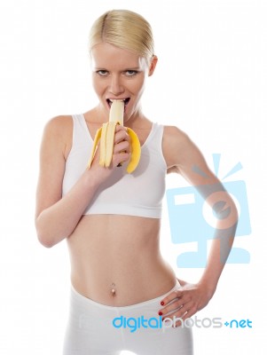 Starving Woman Eating Banana Stock Photo