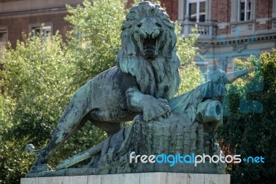 Statue Of A Lion Guarding The Margaret Bridge In Budapest Stock Photo