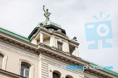 Statue Of A Woman On Top Of A House In Vienna Stock Photo