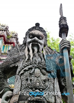 Statue Of Man At Wat Pho In Bangkok, Thailand Stock Photo