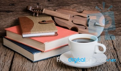 Still Life Cup Of Coffee,book And Violin On Old Wood Background Stock Photo