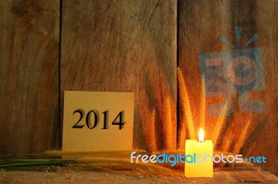 Still Life With 2014 Wrote On Notepad And Candle Light On Wooden… Stock Photo