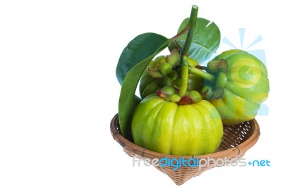 Still Life With Fresh Garcinia Cambogia On Wood Basket. Isolated… Stock Photo