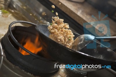 Stir fried rice being cooked in wok Stock Photo