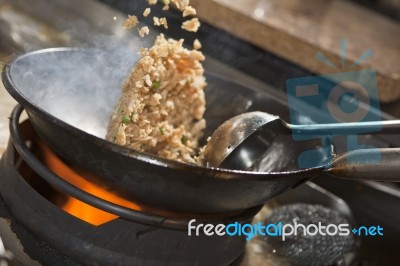 Stir fried rice being cooked in wok Stock Photo