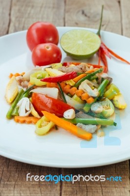 Stir Fry Vegetables In White Dish On Wood Background Stock Photo