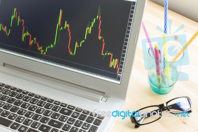 Stock Or Forex Graph In Laptop Screen Stock Photo