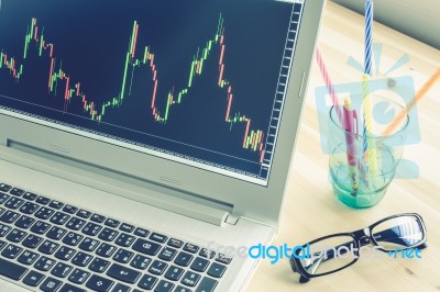 Stock Or Forex Graph In Laptop Screen On Blue Vintage Style Stock Photo