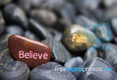 Stone Engraved With Believe Faith Stock Photo