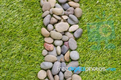 Stone On Grass Background Stock Photo