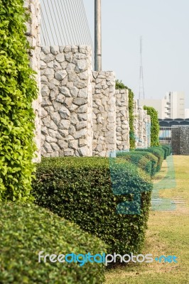 Stone Wall In The Garden For Background Stock Photo