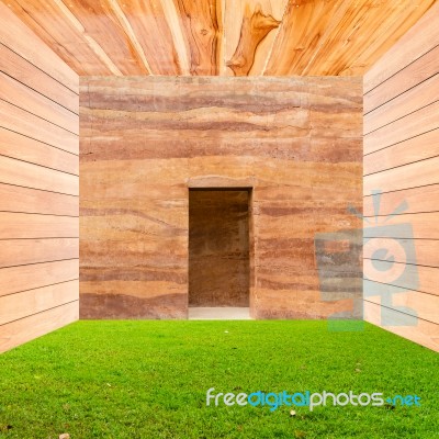 Stone Wall With Door And Green Grass Floor In Wooden Room Stock Photo