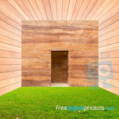 Stone Wall With Door And Green Grass Floor In Wooden Room Stock Photo