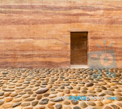 Stone Wall With Door And Stone Floor In Front Off Stock Photo