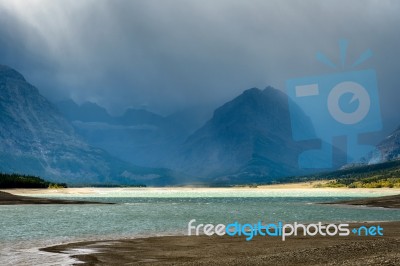 Storm Clouds Gathering Over Lake Sherburne Stock Photo