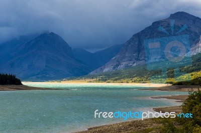 Storm Clouds Gathering Over Lake Sherburne Stock Photo