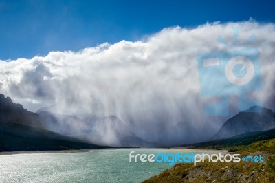 Storm Clouds Gathering Over Lake Sherburne Stock Photo